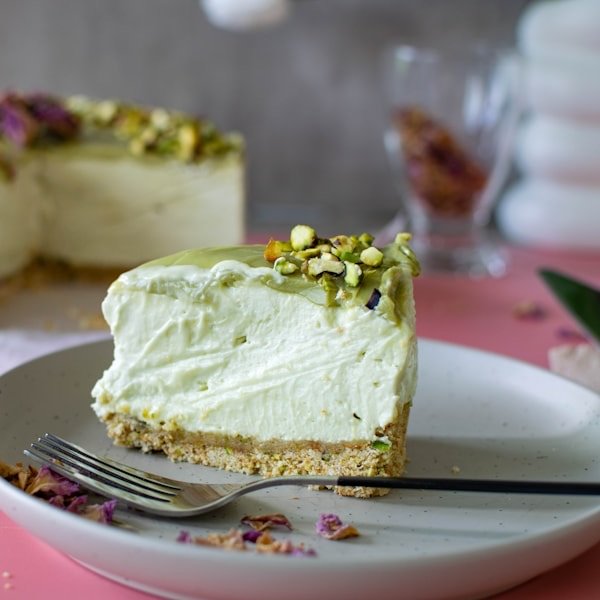 A slice cut from a celebration cake on a pale plate